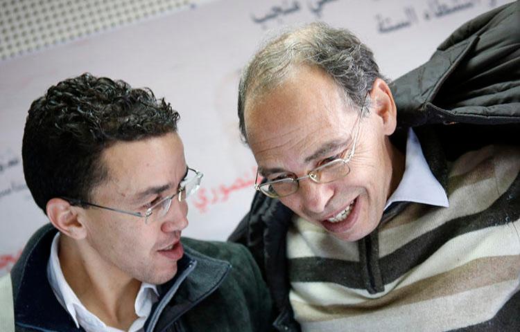 Maati Monjib, right, chats with Moroccan journalist Hicham Mansouri in Rabat, Morocco, January 17, 2016. Amnesty International reported this month that Monjib has been sent malicious messages in an attempt to install spyware on his phone. (AP Photo/Abdeljalil Bounhar)