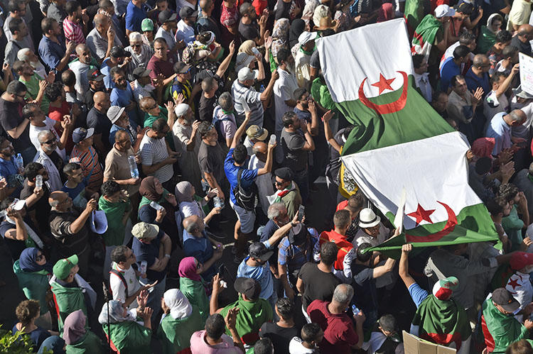 Protesters chant slogans during anti-government demonstrations in Algiers, on October 18, 2019. Police have arrested at least five journalists in recent weeks. (AFP/Ryad Kramdi)