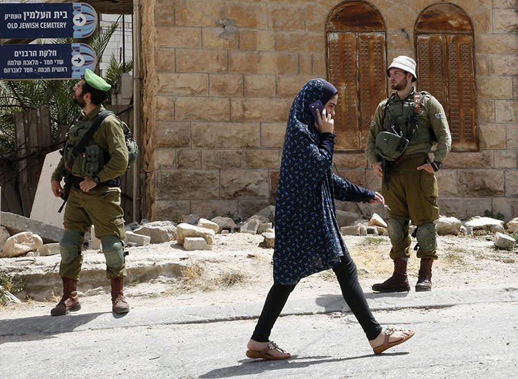 A Palestinian girl talks on her cell phone in the West Bank on July 3, 2018. Palestinian authorities recently blocked dozens of websites throughout the territories. (AFP/Hazem Bader)