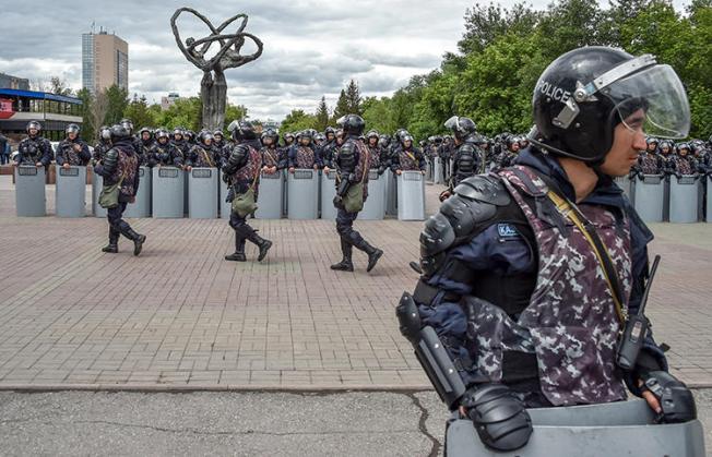 Police officers are seen in Nur-Sultan, Kazakhstan, on June 10, 2019. Kazakh journalist Amangeldy Batyrbekov was recently jailed on criminal libel charges. (AFP/Vyacheslav Oseledko)