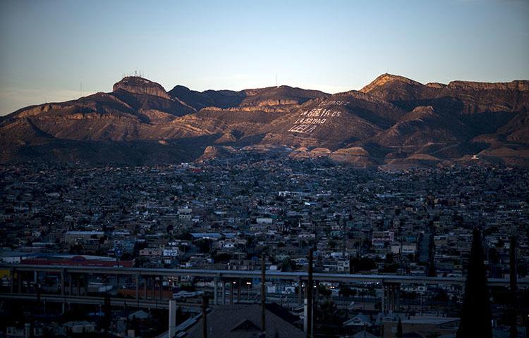 Ciudad Juarez in Mexico is pictured nestled against El Paso, Texas. A member of a National Geographic crew was shot in the leg when gunmen attacked a residence where the group was interviewing an alleged gang member. (Paul Ratje/AFP)