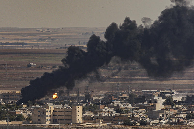 Smoke is seen billowing from the sites of air strikes in Ras al-Ayn, Syria, on October 13, 2019. Syrian Kurdish journalist Saad Ahmed was killed in an airstrike in the town. (AP/Emrah Gurel)