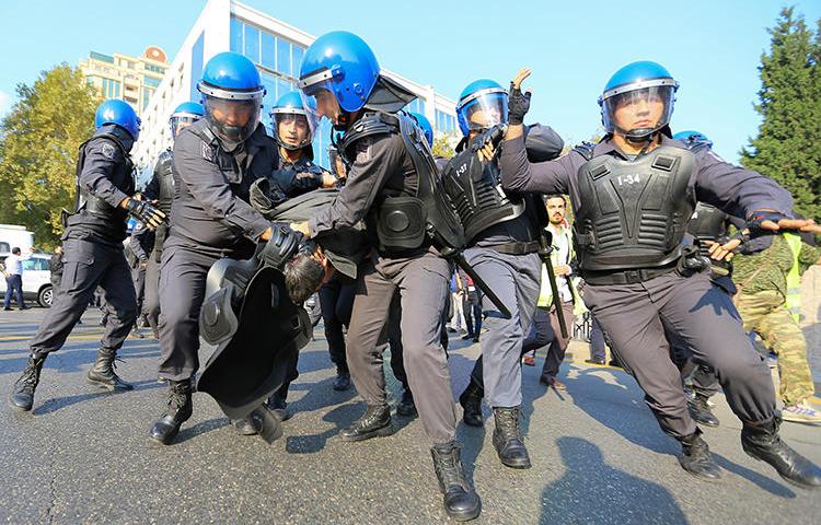 Law enforcement officers detain a protester in Baku, Azerbaijan, on October 19, 2019. Police detained journalist Seymur Hazi in the run-up to the protests. (Reuters/Aziz Karimov)