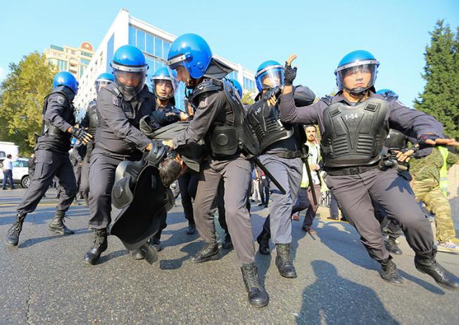 Law enforcement officers detain a protester in Baku, Azerbaijan, on October 19, 2019. Police detained journalist Seymur Hazi in the run-up to the protests. (Reuters/Aziz Karimov)