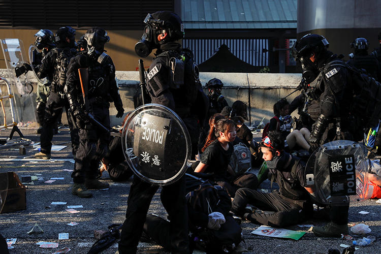 Riot police detain protesters in Wong Tai Sin, Hong Kong, on October 1, 2019. Police arrested journalist Pang Pui Yin, who was covering protests in Mong Kok, and released him the following day. (Reuters/Tyrone Siu)