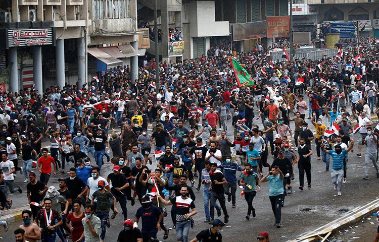 Demonstrators are seen in Baghdad, Iraq, on October 25, 2019. Journalists have been attacked and detained amid the protests. (Reuters/Thaier Al-Sudani)