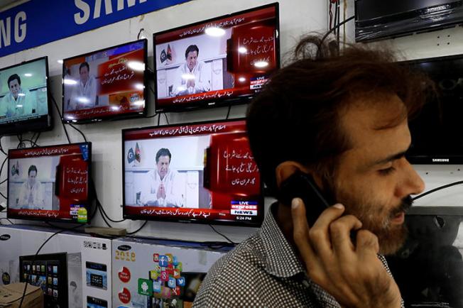 News broadcasts are seen on televisions in Karachi, Pakistan, on July 26, 2018. The country's media regulator recently issued mixed messages regarding news anchors' abilities to express their opinions. (Reuters/Akhtar Soomro)