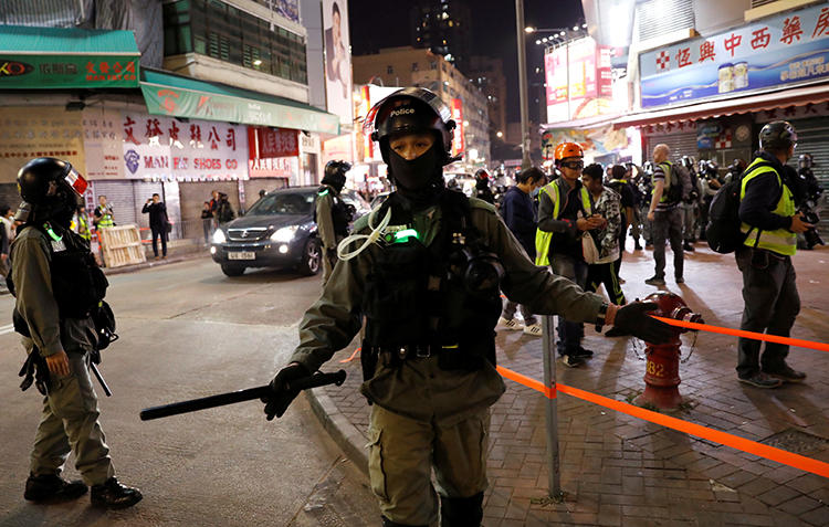 A police officer is seen in Yuen Long, Hong Kong, on November 21, 2019. The Hong Kong print shop of the Epoch Times newspaper was recently damaged in an arson attack. (Reuters/Adnan Abidi)