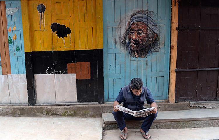 A man reads a newspaper in Bhaktapur, near Kathmandu, in May 2015. Journalists in Nepal say proposed regulations and pressure from authorities are damaging press freedom. (AFP/Prakash Singh)