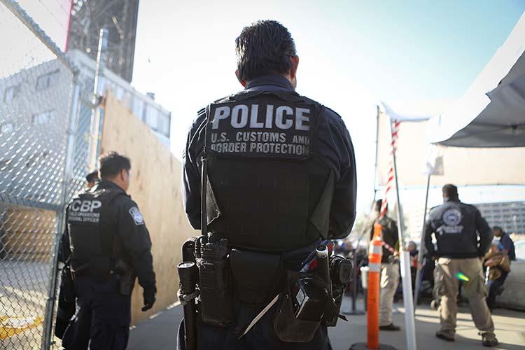 A U.S. Customs and Border Protection officer waits for pedestrians entering the United States on April 9, 2018 at the San Ysidro port of entry in California. Warrantless searches of devices belonging to journalists and other travelers at the border violate the U.S. constitution, a Massachusetts district court judge ruled in November. (Getty Images/AFP/Mario Tama)