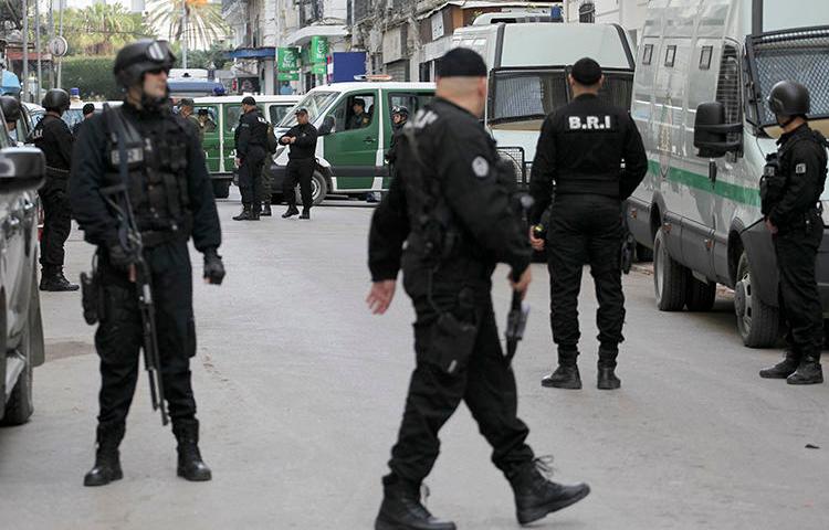 Algerian security forces are seen in Algiers on December 4, 2019. Authorities recently sentenced cartoonist Benabdelhamid Amine to three months in prison. (AP/Toufik Doudou)