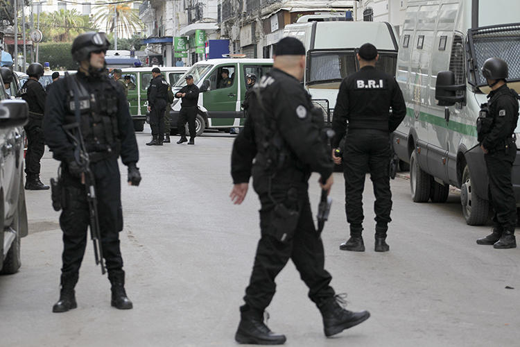 Algerian security forces are seen in Algiers on December 4, 2019. Authorities recently sentenced cartoonist Benabdelhamid Amine to three months in prison. (AP/Toufik Doudou)