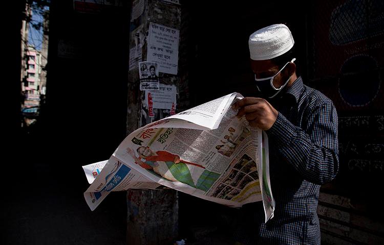 A man reads a newspaper in Dhaka, Bangladesh, on December 31, 2018. Police recently arrested and detained newspaper editor Abdul Asad. (AP/Anupam Nath)