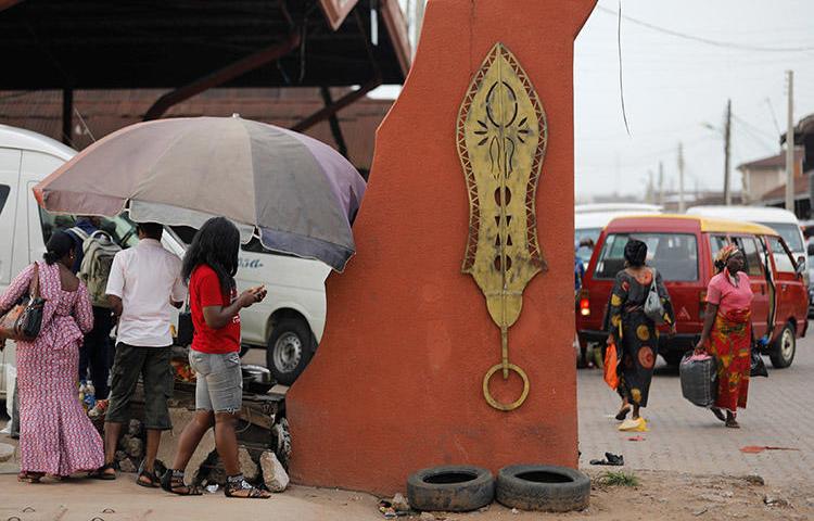 Brass work hangs at the entrance to Igun Street in the Edo state capital of Benin City, in June 2018. A journalist for Rave Television was attacked while covering a protest in the Nigerian city in November 2019. (Reuters/Akintunde Akinleye)