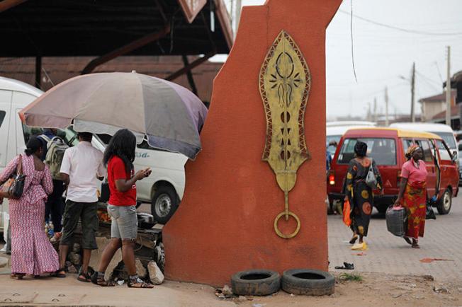 Brass work hangs at the entrance to Igun Street in the Edo state capital of Benin City, in June 2018. A journalist for Rave Television was attacked while covering a protest in the Nigerian city in November 2019. (Reuters/Akintunde Akinleye)