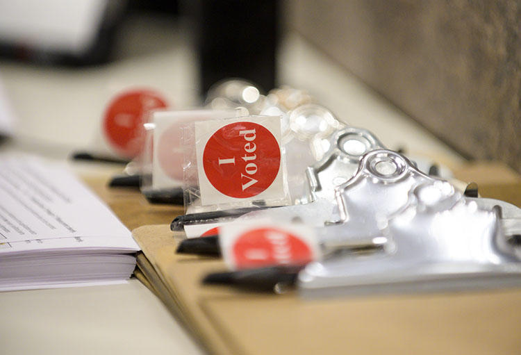 'I Voted' stickers and registration forms pictured on January 17, 2020, the first day of early voting in Minneapolis, Minnesota. CPJ Emergencies has resources and tips for journalists covering the U.S. 2020 election. (Getty/AFP/Stephen Maturen)