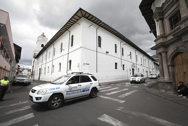 Police vehicles are seen in Quito, Ecuador, on October 13, 2019. Ecuador's broadcast regulator recently revoked radio station Pichincha Universal’s broadcast license. (AP/Fernando Vergara)