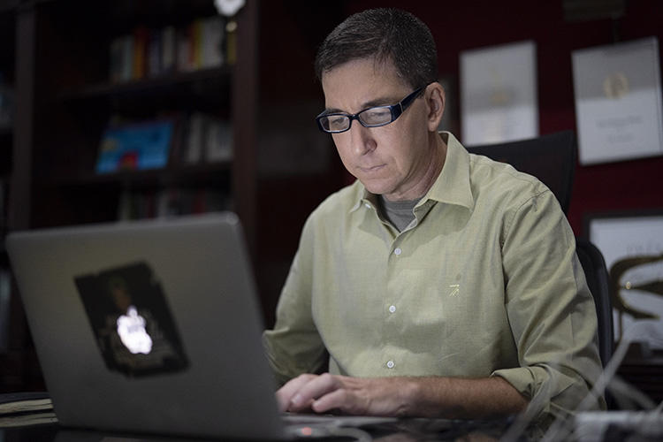 In a July 10, 2019, photo, journalist Glenn Greenwald is shown at his home in Rio de Janeiro, Brazil. Brazil's federal public prosecutor on January 21, 2020, charged Greenwald with crimes including criminal association and invasion of an electronic device in connection with a series of reports published in The Intercept Brasil in June 2019. (AP Photo/Leo Correa)