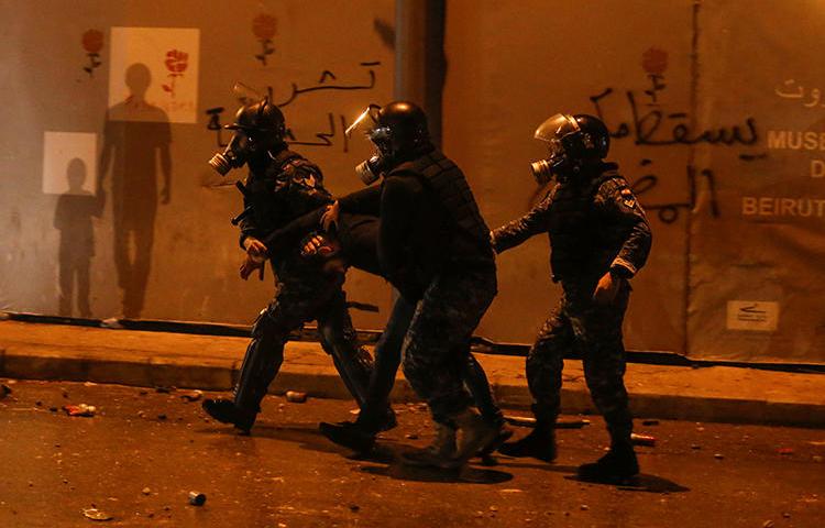 Riot police restrain a protester in Beirut, Lebanon, on January 18, 2020. Authorities arrested U.S. freelancer Nicholas Frakes and held him for two days. (Reuters/Mohamed Azakir)