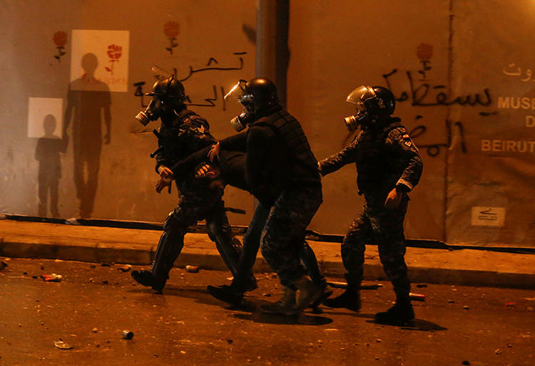 Riot police restrain a protester in Beirut, Lebanon, on January 18, 2020. Authorities arrested U.S. freelancer Nicholas Frakes and held him for two days. (Reuters/Mohamed Azakir)