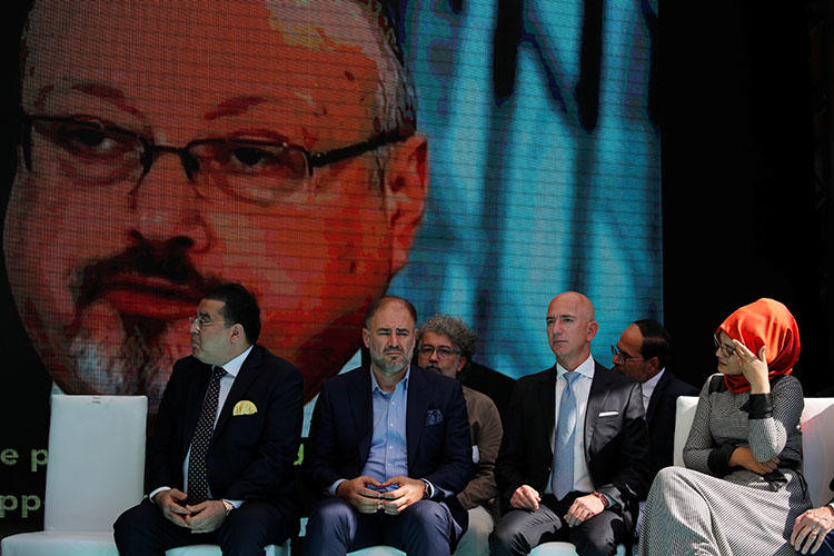 Hatice Cengiz, fiancee of the murdered Saudi journalist Jamal Khashoggi, and Jeff Bezos, founder of Amazon and owner of The Washington Post, are flanked by attendees at a ceremony marking the first anniversary of Khashoggi's killing at the Saudi Consulate in Istanbul, Turkey, on October 2, 2019. (Reuters/Umit Bektas)