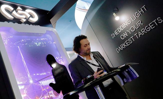 A man reads at a stand of the Israeli technology firm NSO Group at the annual European Police Congress in Berlin, Germany, February 4, 2020. WhatsApp has alleged the group's technology enabled the remote surveillance of members of civil society via their phones, with several Indian journalists among the targets. (Reuters/Hannibal Hanschke)