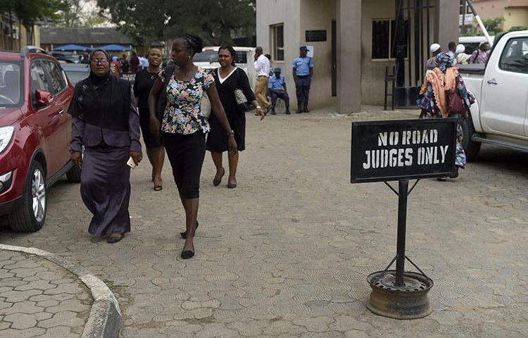 People walk at the premises of Lagos State High Court on January 29, 2019. Nigerian journalist Fejiro Oliver faces cybercrime charges in Lagos for a corruption report. (AFP/Pius Utomi Ekpei)