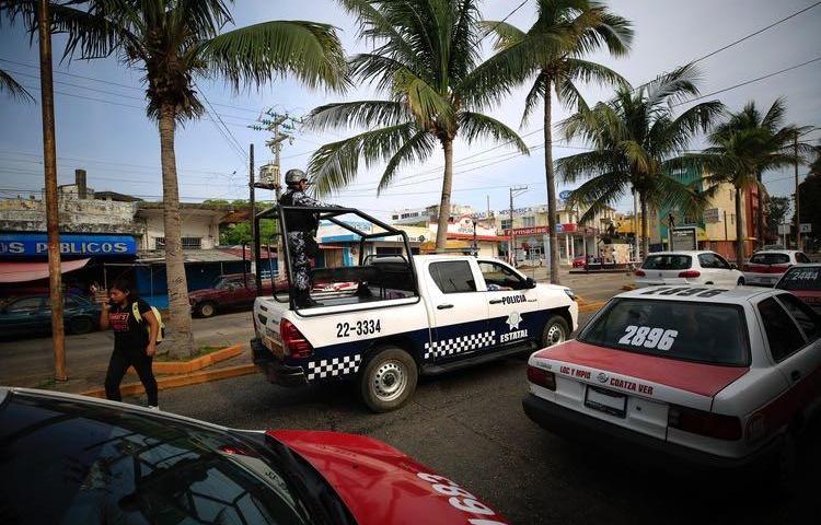 A state police truck patrols in Coatzacoalcos, Veracruz state, Mexico, on August 30, 2019. Mexican police attacked reporters during a protest in Ciudad Isla, Veracruz, on February 11, 2020. (AP Photo/Rebecca Blackwell)