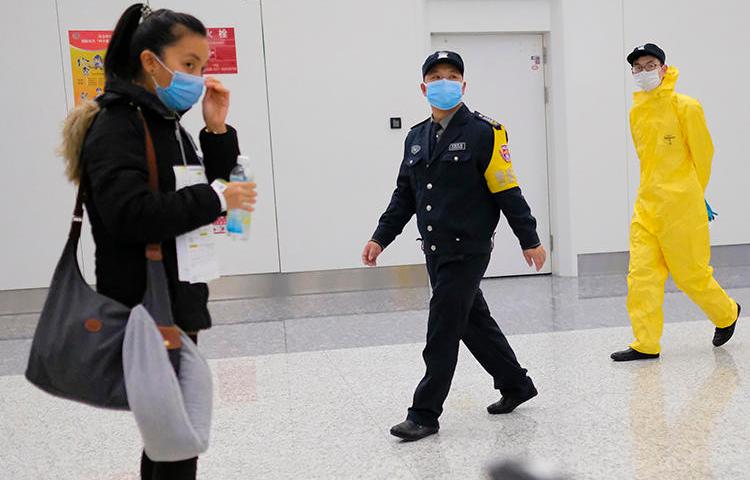 Workers wearing protective equipment are seen in Wuhan, China, on February 1, 2020. Journalist Chen Qiushi was reporting in Wuhan and has not been seen since February 6. (AP/Arek Rataj)