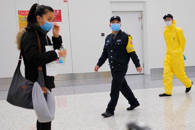 Workers wearing protective equipment are seen in Wuhan, China, on February 1, 2020. Journalist Chen Qiushi was reporting in Wuhan and has not been seen since February 6. (AP/Arek Rataj)