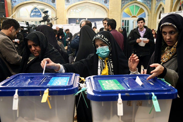 A woman wears a face mask as she casts her vote during parliamentary elections at a polling station in Tehran, Iran February 21, 2020. Iranian authorities detained journalist Mohammad Mosaed the next day for his social media posts. (Nazanin Tabatabaee/West Asia News Agency via Reuters)