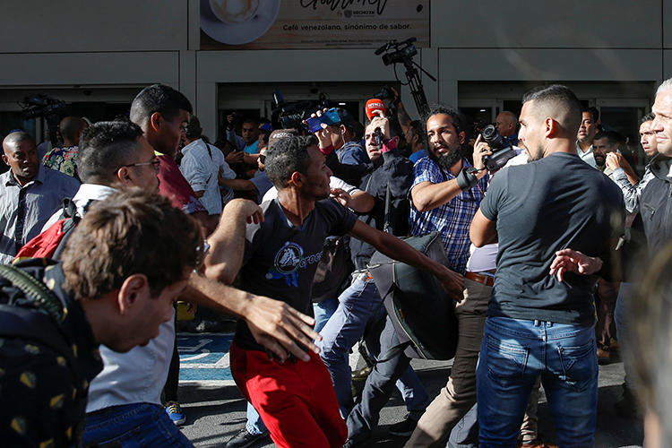 Supporters of Venezuelan President Nicolas Maduro scuffle with members of the media at the Simon Bolivar international airport in Maiquetia, Venezuela, on February 11, 2020. (Reuters/Manaure Quintero)