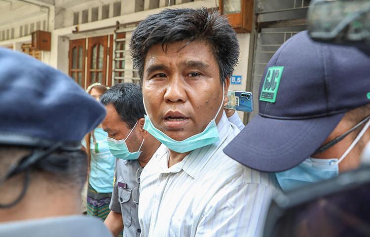 Voice of Myanmar editor-in-chief Ko Nay Lin is escorted by police to court in Mandalay, Myanmar, on March 31, 2020. He is facing life in prison on terrorism charges for his reporting. (AFP/Zaw Zaw)