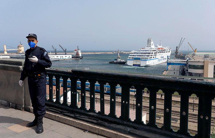 A police officer is seen in Algiers, Algeria, on March 19, 2020. Algerian authorities recently imprisoned journalist and RSF correspondent Khaled Drareni. (AP/Toufik Doudou)