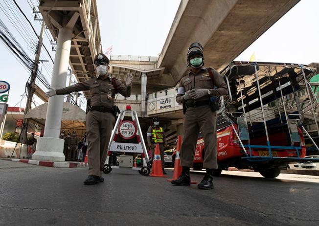 Police officers are seen in Bangkok, Thailand, on March 26, 2020. The Thai government has imposed a state of emergency in response to the COVID-19 outbreak, and has restricted the press. (AP/Sakchai Lalit)