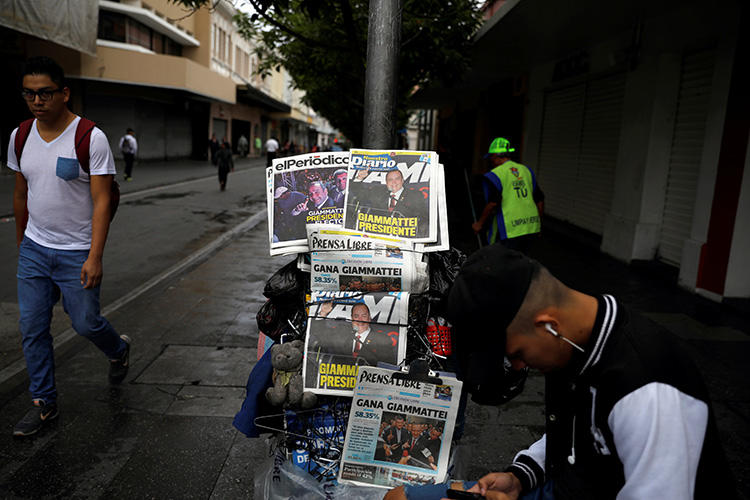 Newspaper headlines announce the election of Guatemala’s new president, Alejandro Giammattei, on August 12, 2019.  A spokesperson for Giammattei says the administration is committed to transparency and making information available through a range of media outlets. (Reuters/Jose Cabezas)