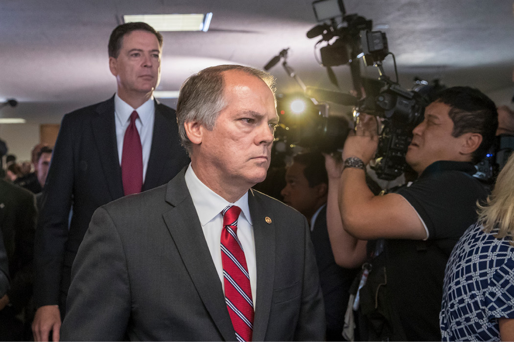 James Wolfe, center, former director of security with the Senate Intelligence Committee, escorts former FBI Director James Comey to a secure room for his testimony on the 2016 election and his firing by President Trump, on Capitol Hill in Washington on June 8, 2017. Federal prosecutors charged Wolfe with lying to the FBI about his contacts with reporters. (AP/J. Scott Applewhite)