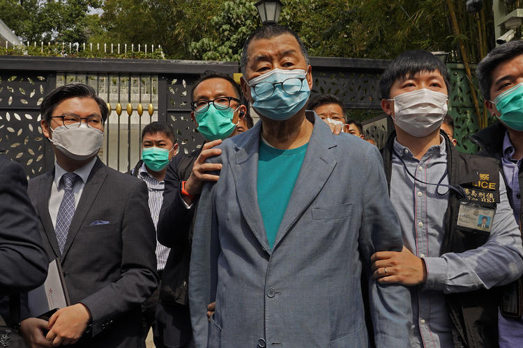 Hong Kong media tycoon Jimmy Lai, center, who founded local newspaper Apple Daily, is arrested by police officers at his home in Hong Kong, Saturday, April 18, 2020. Hong Kong police arrested at least 14 pro-democracy lawmakers and activists on Saturday on charges of joining unlawful protests last year calling for reforms. (AP/Vincent Yu)