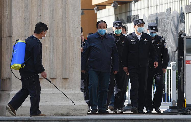 Police are seen in Beijing, China, on April 27, 2020. Police recently arrested two media workers in Beijing, and a third is missing. (AFP/Greg Baker)