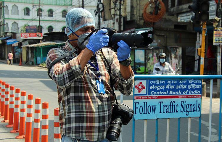 AFP photographer Diptendu Dutta works during a government-imposed nationwide lockdown as a preventive measure against the spread of COVID-19 in Siliguri, India, on April 10, 2020. Freelance journalists have faced risks to their lives and livelihoods amid the COVID-19 pandemic. (AFP)