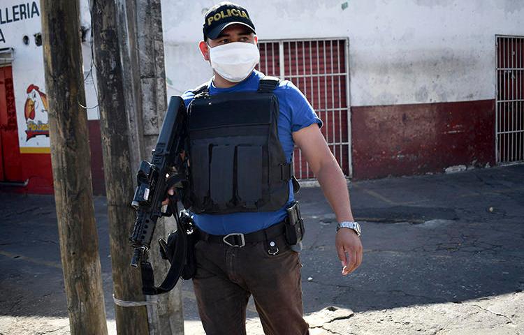 A police officer is seen in Guatemala City on March 22, 2020. Journalist Carlos Choc's home was recently robbed in southeast Guatemala. (AFP/Johan Ordonez)