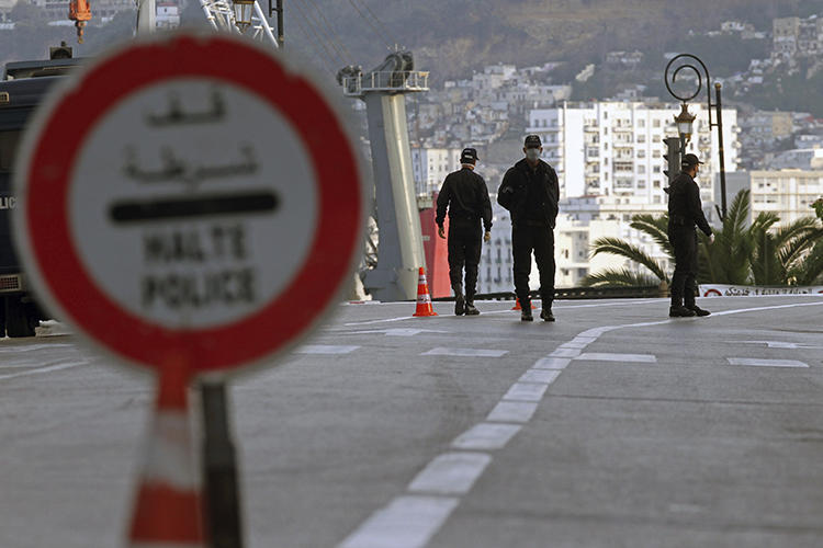 Security forces are seen in Algiers, Algeria, on April 8, 2020. Algerian authorities recently blocked three news websites in the country and passed legislation criminalizing "fake news." (AP/Toufik Doudou)