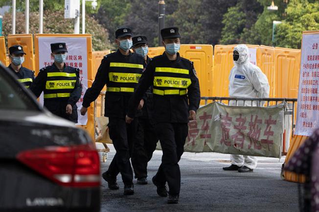 Police officers are seen in Wuhan, China, on April 4, 2020. (AP/Ng Han Guan)