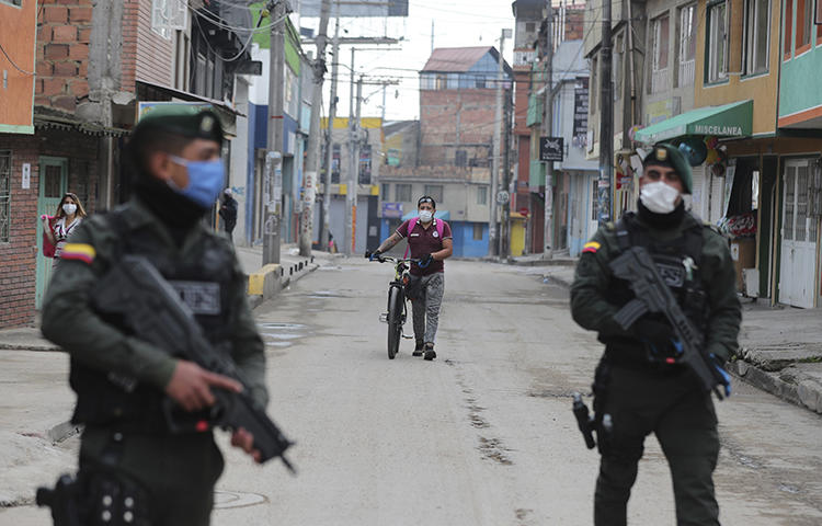 Police are seen in Bogota, Colombia, on March 25, 2020. Authorities recently suspended meetings of the country's journalist protection program amid fears of the COVID-19 pandemic. (AP/Fernando Vergara)