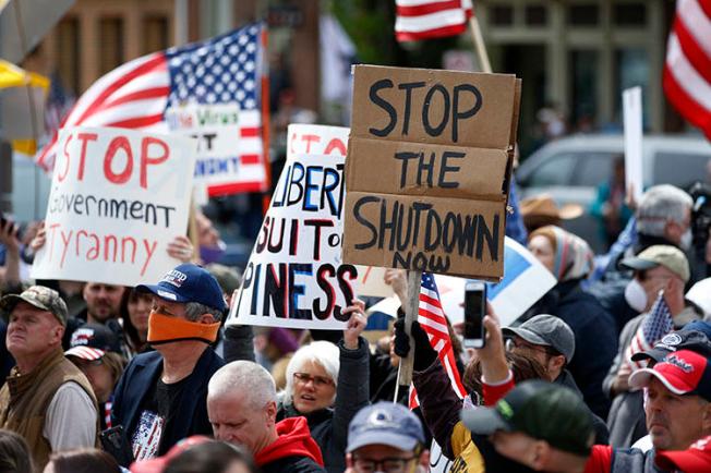 Protesters demonstrate at the state capitol in Harrisburg, Pa., on April 20, 2020, demanding that Gov. Tom Wolf reopen Pennsylvania's economy even as new social-distancing mandates took effect at stores and other commercial buildings to stem the spread of the coronavirus. (AP Photo/Matt Slocum)