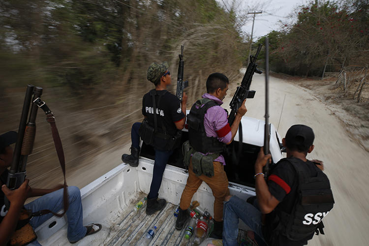 Members of the vigilante group Frente Unido de Policías Comunitarias de Guerrero are seen in Guerrero state, Mexico, on May 29, 2019. The group recently made threats against Proceso reporter Ezequiel Flores. (AP/Rebecca Blackwell)