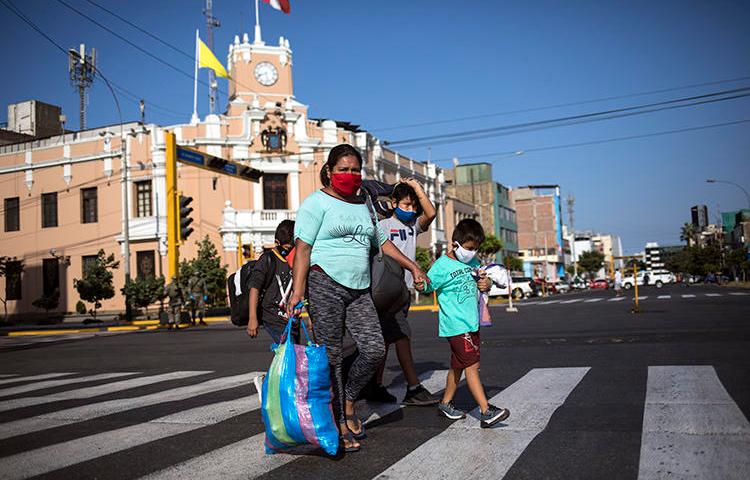 A family is seen in Lima, Peru, on April 23, 2020. Peruvian cartoonist Carlos Tovar Samanez recently received death threats for his work. (AP/Rodrigo Abd)