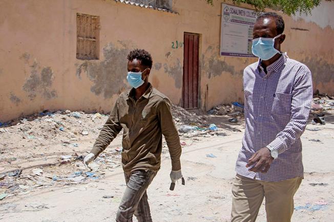 Men are seen in Mogadishu, Somalia, on March 18, 2020. Somali authorities recently arrested journalist Abdiaziz Ahmed Gurbiye over his COVID-19 Facebook posts. (AP/Farah Abdi Warsameh)