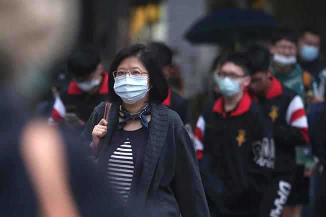 People walk on a street in Taipei, Taiwan, on March 30, 2020. CPJ recently spoke with journalist Brian Hioe on covering COVID-19 in Taiwan. (AP/Chiang Ying-ying)