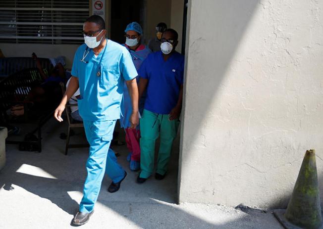 Medical staff are seen in Port-au-Prince, Haiti, on March 27, 2020. CPJ recently spoke with Haitian journalist Robenson Sanon about covering the COVID-19 pandemic. (Reuters/Jeanty Junior Augustin)